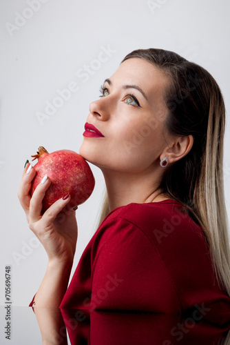 Beautiful Blonde with Red Lipstick and Pomegran Creative Makeup - Studio Concept on White Background photo