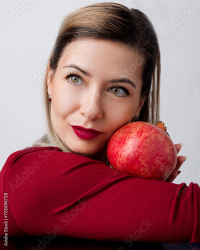 Beautiful Blonde with Red Lipstick and Pomegran Creative Makeup - Studio Concept on White Background photo