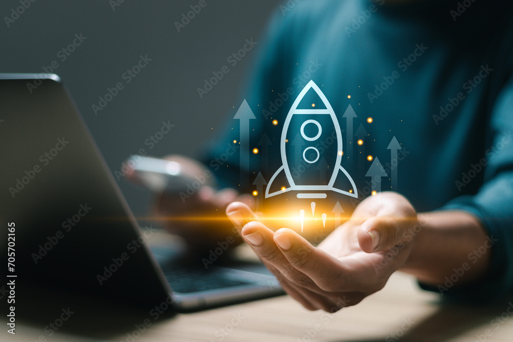 Startup business concept, Businessman use laptop with virtual screen of rocket icon and up arrow for fast start up business. Strategic planning and business success. - obrazy, fototapety, plakaty 