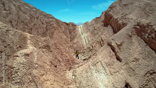 Beautiful aerial footage of the a person walking alone in the Atacama Dessert - Calama - Antofagasta Dessert and Salar - turquoise lagoon. photo