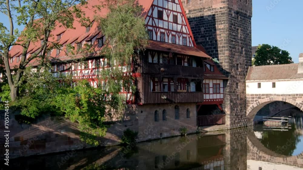 Tilt up from reflection of Wasserturm in the River Pegnitz in Nuremberg, Germany. Taken on a still summer after noon