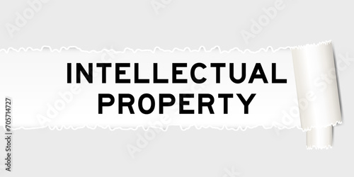Ripped gray paper background that have word intellectual property under torn part