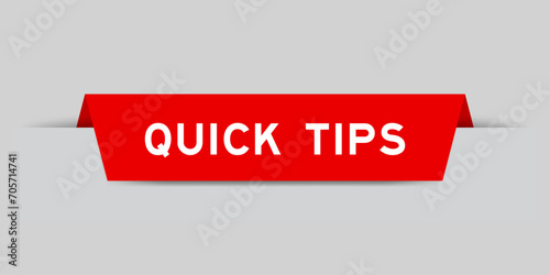 Red color inserted label with word quick tips on gray background