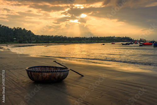 Fishing boats at My Khe beach with sunrise in Danang , Vietnam, Bamboo basket boat, Local fishing boats in Vietnam photo