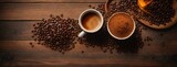 Coffee cup and beans on a wooden tabletop close-up overhead shot, copy space for text. Savor the simplicity of a close-up coffee composition, featuring beans and a cup on a textured wooden background.