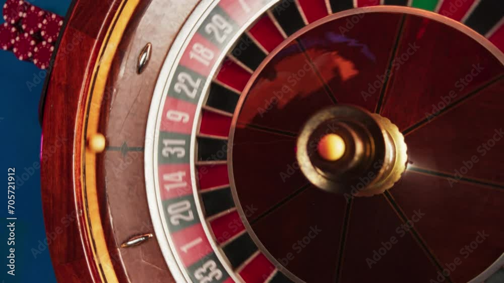 Close Up Top Down Spinning Shot Of Ball Rolling On Roulette In Luxurious Casino. Chips Are Laying On The Table, Players Made Bets, Waiting for Ball To Fall In Red Or Black. Betting, Gambling Concept Close Up Top Down Spinning Shot Of Ball Rolling On Roulette In Luxurious Casino. Chips Are Laying On The Table, Players Made Bets, Waiting for Ball To Fall In Red Or Black. Betting, Gambling Concept
