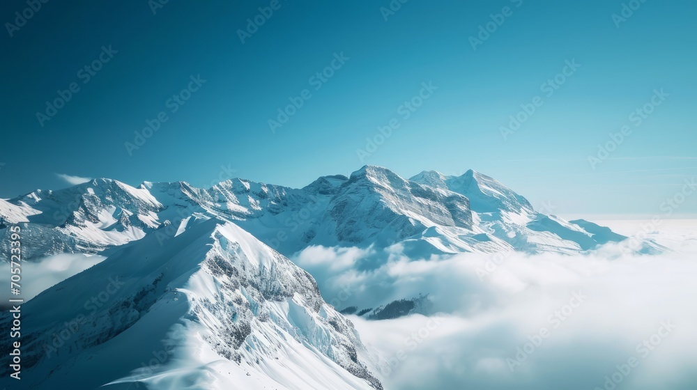 Snow-Covered Mountains Above Clouds