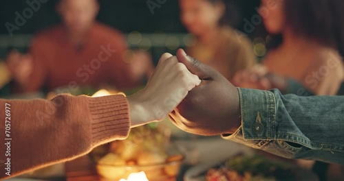 Closeup, holding hands and praying, food and friends worship together, gratitude and thanks to God at dinner party. Men, women with nutrition and religion, celebration and social event at night photo