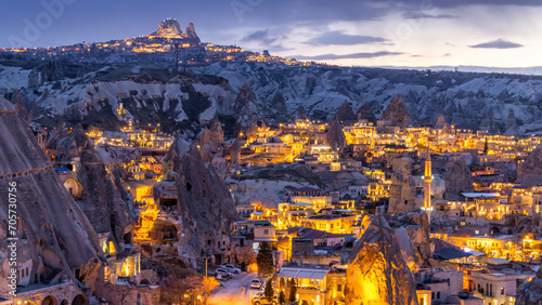 Goreme City at twilight, Famous tourist center of balloon fligths in Cappadocia, Turkiye, Aerial view twilight Goreme City from the mountain, Night view of Goreme, Cappadocia, Turkey. photo