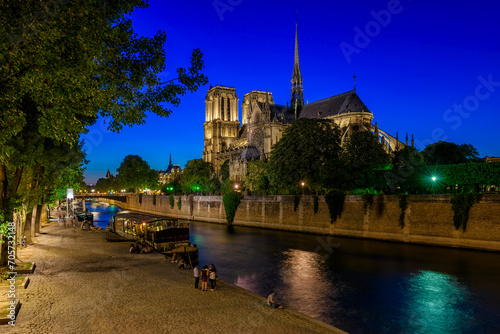 Night view of Cathedral Notre Dame de Paris, island Cite and river Seine in Paris, France. Cityscape of Paris. Architecture and landmarks of Paris