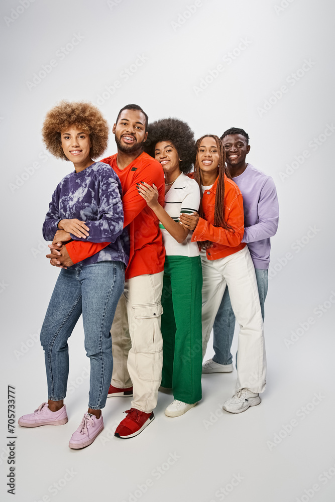 joyful african american people in casual attire posing together on grey backdrop, Juneteenth concept joyful african american people in casual attire posing together on grey backdrop, Juneteenth concept