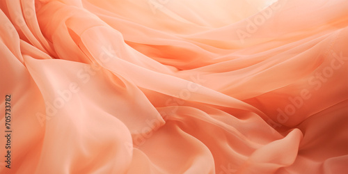 Soft peach fabric folds texture. Peach Fuzz 2024 color. A close up of a peach colored fabric. Fashion and luxury textile design. Suitable for backdrop, banner, wallpaper Monochrome peach fuzz backgrou
