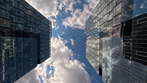 Time-lapse of skyscraper buildings in business district, Bucharest city. Clouds on sunny day sky. Low angle view. Romania financial skyline modern architecture concept photo