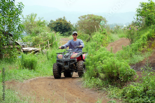 Asian man playing ATV Ride Adventure Tour in Malang, Indonesia