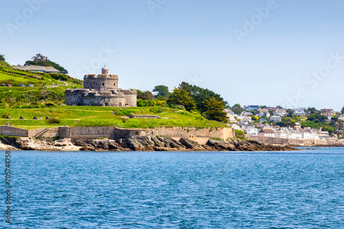 St Mawes, Cornwall, UK - St Mawes Castle and the popular village of St Mawes, from the water. Built by Henry VIII to defend against French invasion.
