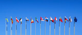 Poles with flags of the countries members of the European Union on blue sky background at the European Parliament in Strasbourg, Europe web banner