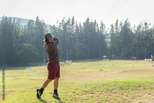 lifestyle playing game golf approach tee of on the green grass mountain background. asian female player game shot in summer