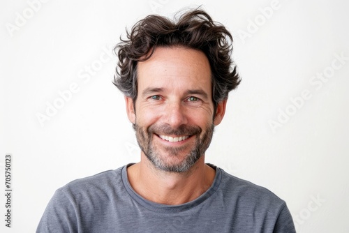 Charismatic portrait of a European man, engaging smile, white background © furyon