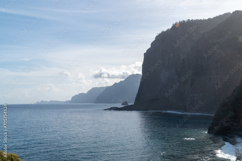 Waves crashing into the cliffs of madeira island