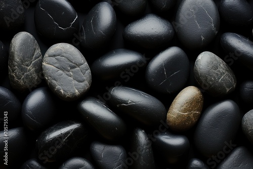  a close up of a bunch of rocks with a yellow and black rock on top of one of the rocks and the other black and white rock on the other side of the rocks.