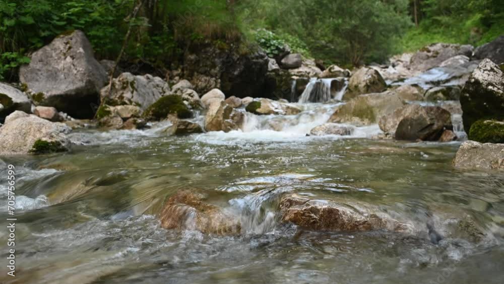 Waterflow of a rocky mountain stream after sunset in summer Waterflow of a rocky mountain stream after sunset in summer