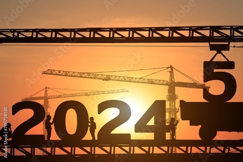 Wallpaper Mural Silhouette staff works as a to prepare to welcome the new year 2025 Torontodigital.ca