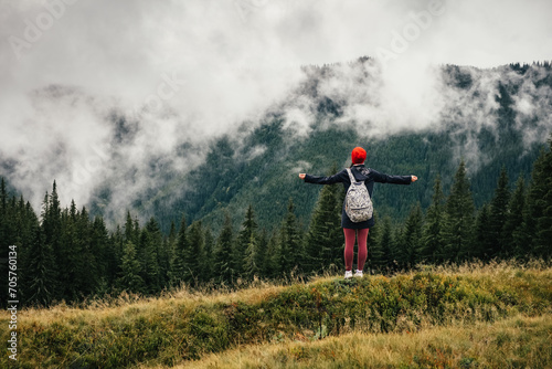 Female hiker feeling free and enjoy mountain nature at autumn