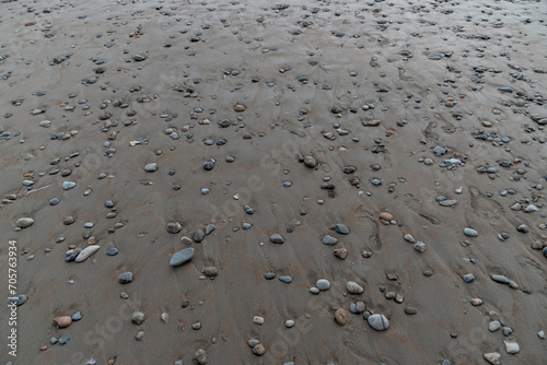 Beach with stones pebbles in dark sand Dominical Costa Rica