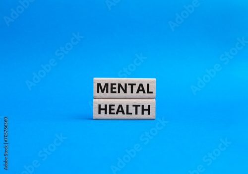 Mental Health symbol. Concept word Mental Health on wooden blocks. Beautiful blue background. Psychology and Mental Health concept. Copy space
