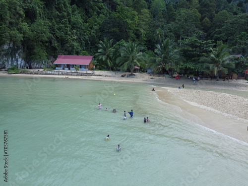 A Day at the Beach: People Enjoying the Sun, Sand, and Ocean in sawai saleman, maluku, indonesia photo