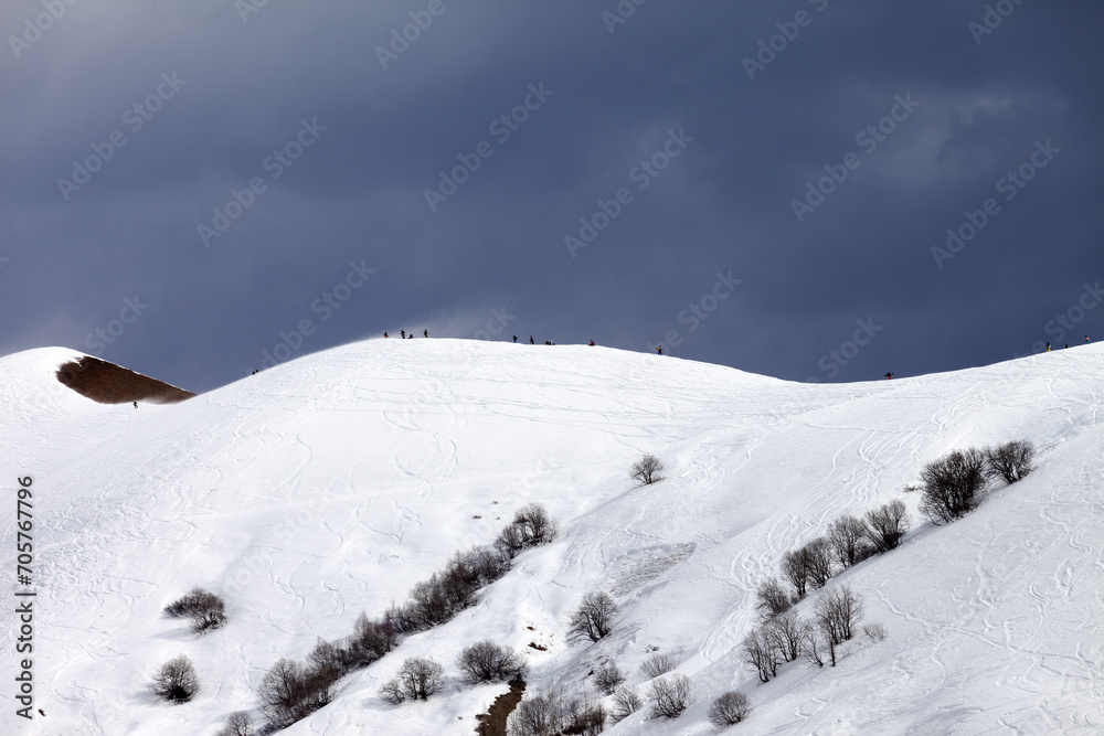 Off piste slope and overcast sky in windy day