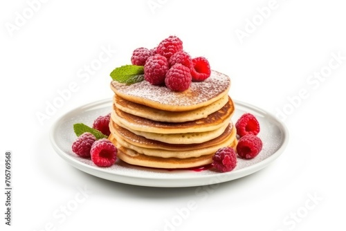  a stack of pancakes topped with raspberries and powdered sugar on a white plate with mint leaves and raspberries on top of the plate on a white background.
