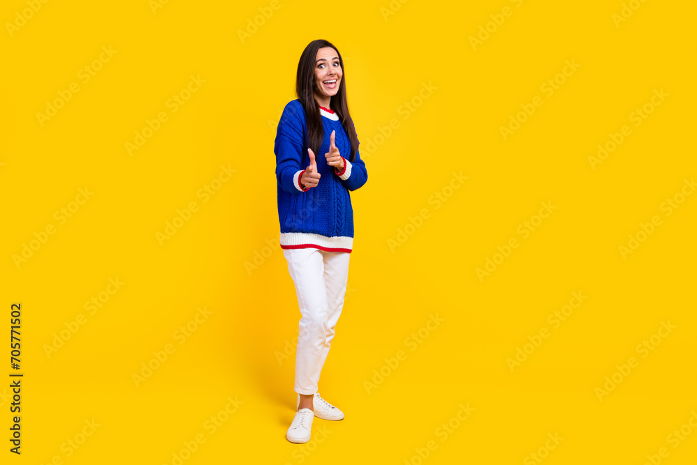 Full body size photo of excited brunette hair funny woman directing forefingers cool event for you isolated on yellow color background Full body size photo of excited brunette hair funny woman directing forefingers cool event for you isolated on yellow color background