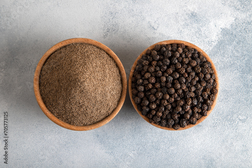  Ground black pepper with grains of black pepper on bright background 