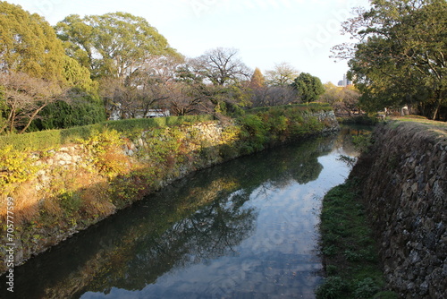 Himeji Castle moat and autumn leaves in dusk, in Himeji, Japan