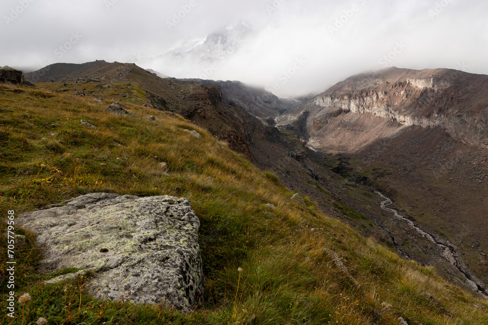 Panoramic landscape of glacial mountain valley during summer in Caucasus mountains