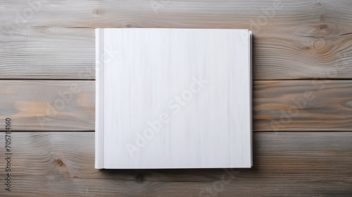 White book on wooden table. Mockup for design, education or branding to place your text.