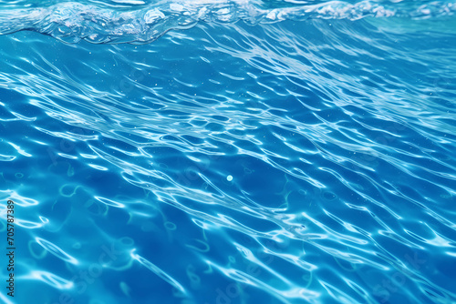 Close Up On A Picture Of A Blue Water Surface, Water With Ripples And Bubbles