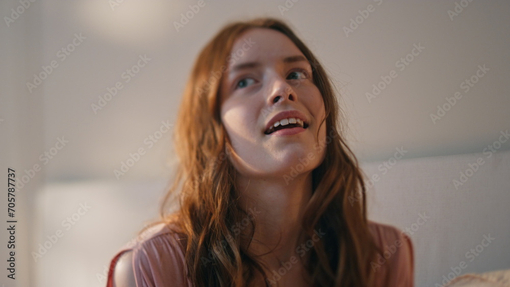 Closeup dreamy girl holding smartphone in bedroom. Smiling teenager get message Closeup dreamy girl holding smartphone in bedroom. Smiling teenager get message