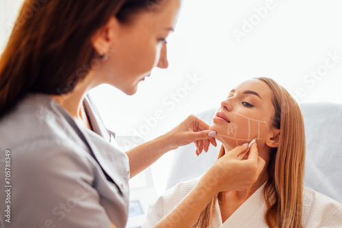 Doctor checking woman face skin in cosmetology clinic before plastic surgery