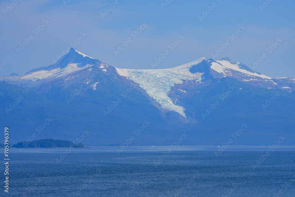 Hanging glacier towering above the coastal waters of the Inside Passage on a mountainous slope in Southeastern Alaska in the Pacific Ocean, USA