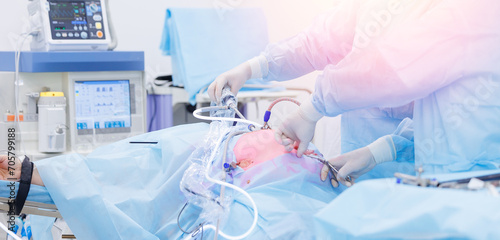 Banner minimally invasive surgery, team doctors use medical equipment, operating room hospital. Surgeon holding laparoscopic instrument in abdomen of patient photo