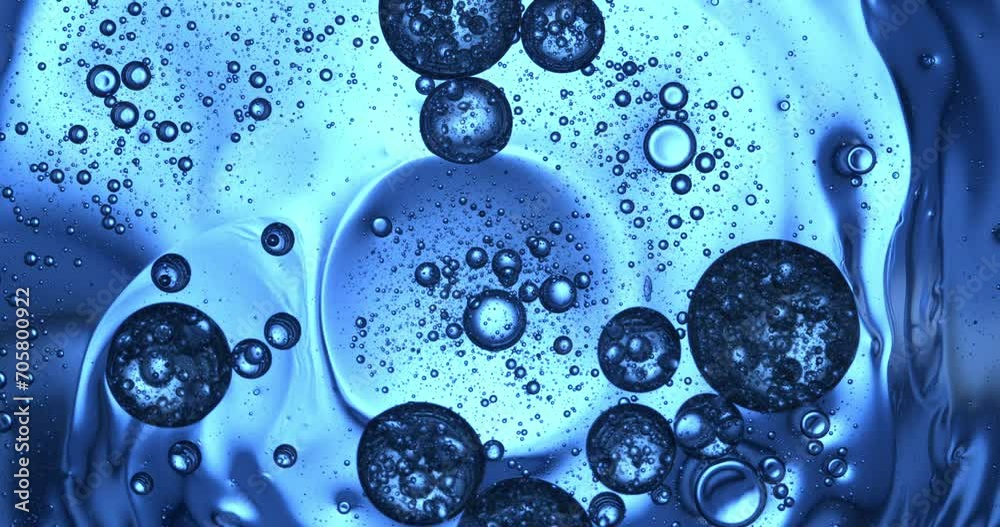 Slow motion macro of floating micro particles molecules in liquid are analyzed with microscope by chemist during innovative new medical research and analysis in scientific pharmaceutical laboratory.