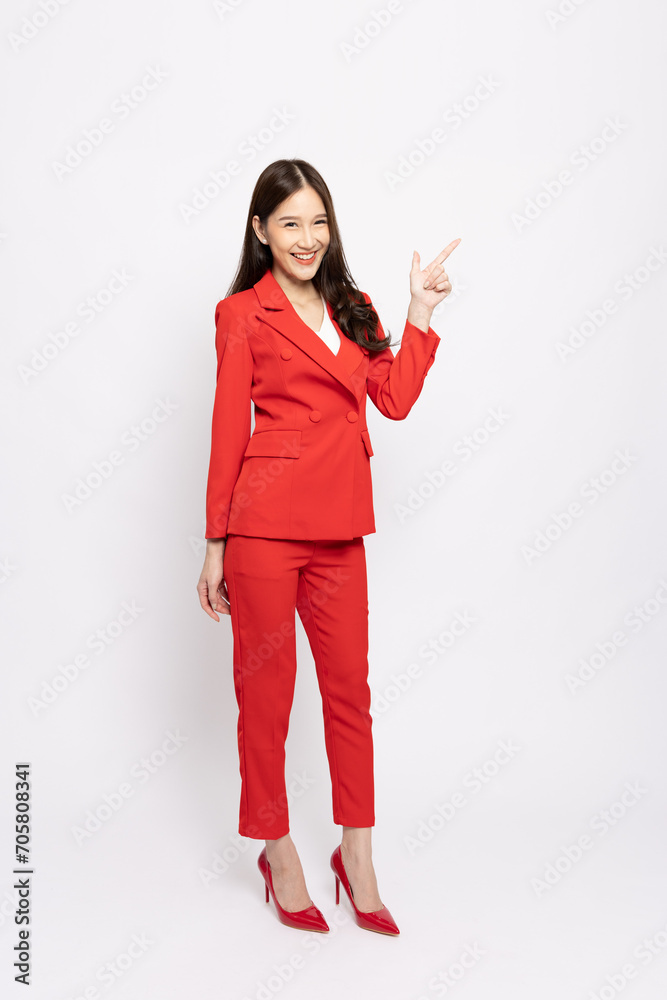 Young beautiful Asian businesswoman smiling and pointing to empty copy space isolated on white background Young beautiful Asian businesswoman smiling and pointing to empty copy space isolated on white background