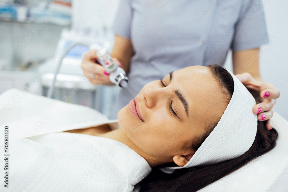 Caucasian woman getting face peeling procedure in a beauty clinic Caucasian woman getting face peeling procedure in a beauty clinic