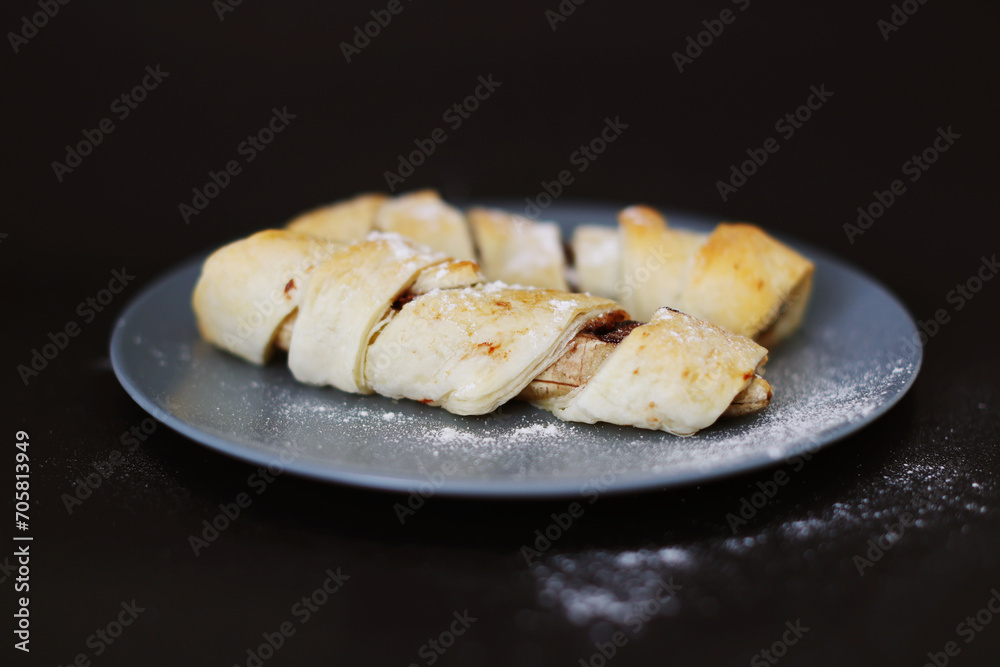 homemade bananas in dough on a black background