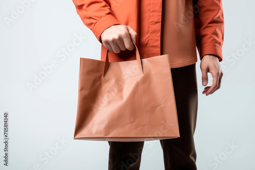 hand of man carrying shopping bag on white background
