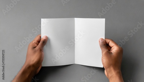 a4 z fold brochure mock up male hands holding a blank tri fold on a gray background