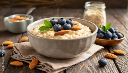 oatmeal porridge with blueberries almonds in bowl on wooden table background healthy breakfast food