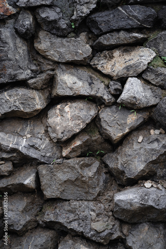 Vertical natural masonry stone background, gray stone